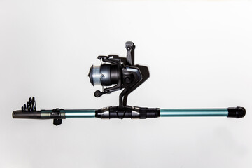 close-up of fishing reel with fishing rod on a white background isolated. Top view. Copy space.