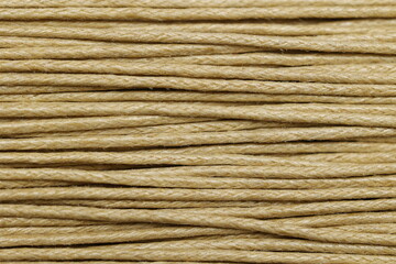 Close-up texture of tightly wound natural fibers forming a strong twine