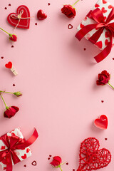 Love tokens: vertical top view of gift boxes, red roses, heart-shaped confetti on a pastel pink base. Create a romantic statement with this delightful composition