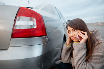 woman stand near scratched auto. call for help. car insurance.