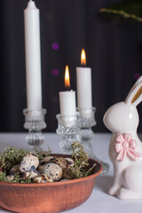 Easter quail eggs and Easter bunny. A bouquet of fluffy willow in a vase, the concept of an Easter holiday in the village