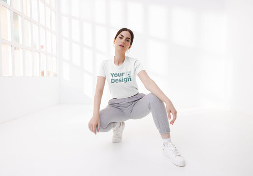 Mockup of woman wearing customizable t-shirt, crouching