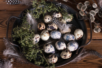 Rustic Easter, quail eggs in a ceramic bowl on the table. The Bright Easter Holiday