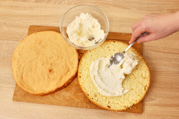 Adding the filling to the cake. Cooking a festive pie at home