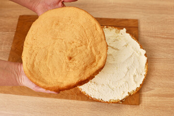 Adding the filling to the cake. Cooking a festive pie at home