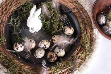 Easter quail eggs and Easter bunny. A bouquet of fluffy willow in a vase, the concept of an Easter holiday in the village