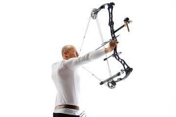 Bald man in his 40s, archery athlete exercising with the bow, aiming upwards isolated over white studio background. Concept of professional sport and hobby, competition, action, game
