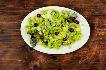 Healthy diet, salad of kiwi and herbs.