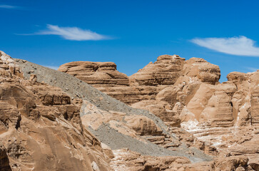 Obraz premium high rocky mountains in the desert against the blue sky and white clouds in Egypt Dahab South Sinai