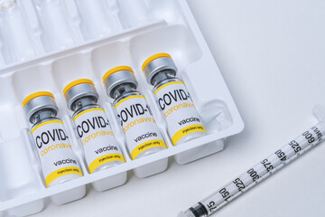 Vaccine in glass vial with syringe on a table. Vaccination, immunization, treatment to Covid 19 Corona Virus infection. Healthcare And Medical concept.