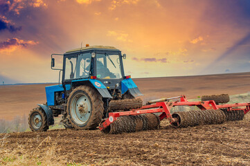 small blue tractor plowing the ground Let's bring life back to earth! Watch as this little blue...