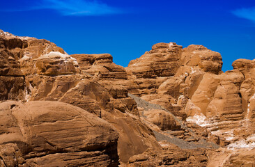 Fototapeta premium peaks of high stone rocks against a blue sky in Egypt Dahab South Sinai