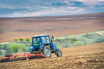 Unleashing the Power of Precision Marvel at the skillful maneuvers of this little blue tractor as...