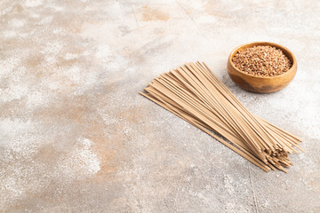 Fototapeta na wymiar Japanese buckwheat soba noodles on brown concrete. Side view, copy space.