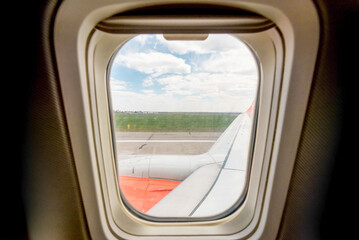 view from the airplane window of the airport during takeoff