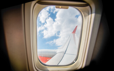 Fototapeta premium view from the airplane window to the blue sky and white clouds