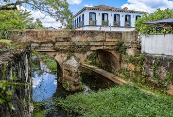 Old stone bridge over the Santo Antonio river,  located in Largo das Forras, Tiradentes, MG, Brasil