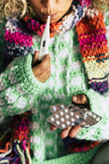 SIck woman at home check fever temperature and take pills medicine to fight influenza flu and cough - coronavirus covid-19 breakout people with science and care