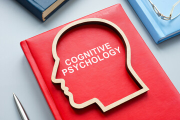 Table with a book about cognitive psychology. - obrazy, fototapety, plakaty