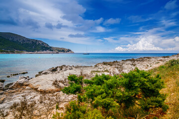 Naklejka na ściany i meble Turquoise sea and the coastline's natural charm near Cala Agulla beach in Mallorca