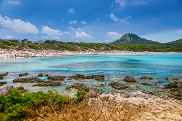 Scenic coastal cliffs and turquoise transparent waters in Cala Agulla beach in Mallorca