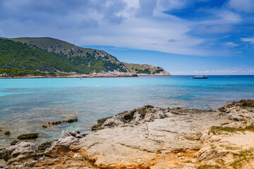 Fototapeta na wymiar Cala Agulla beach in Mallorca with crystal-clear waters and scenic natural surroundings
