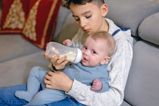 Happy family, newborn baby and older brothers, mom at home on Christmas