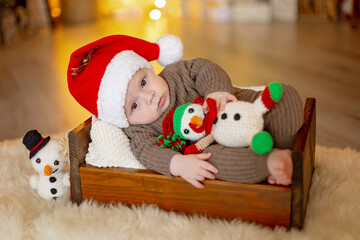 Cute newborn child, baby boy, with mom and dad on Christmas