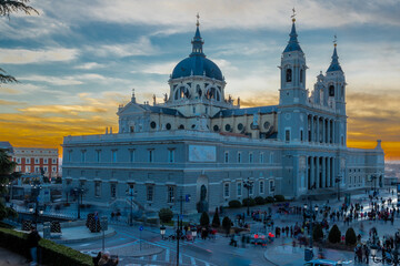 Madrid, Spain 28-12-2022 The Almudena Cathedral during a colorful sunset, it is the most important  and Catholic religious building in Madrid and a visit is free of charge except for the crypt   - obrazy, fototapety, plakaty
