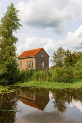 Tiny brick house along lake called Leekstermeer municipality Westerkwartier in Groningen province The Netherlands