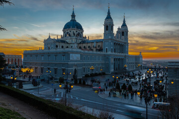 Fototapeta na wymiar Madrid, Spain 28-12-2022 The Almudena Cathedral during a colorful sunset, it is the most important and Catholic religious building in Madrid and a visit is free of charge except for the crypt 