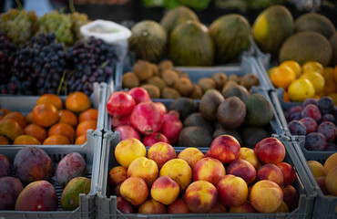 Fruit market in Porto with various colorful fresh fruits and vegetables. Mango, nectarine.