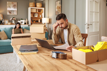 Small business owner packing in the cardbox at workplace