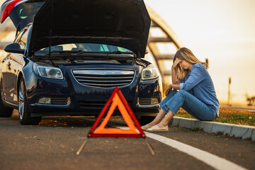 Woman driver using mobile phone during problem car
