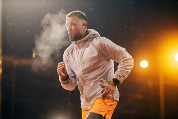 An urban runner is running on city street on snowy cold weather at night.