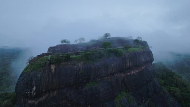 Fly around popular tourist attraction. Lions rock with ancient fortress and gardens. Low clouds in morning. Sigiriya, Sri Lanka