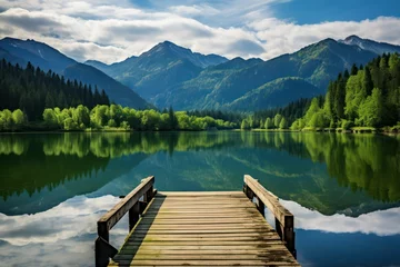 Fotobehang Serene lake view with wooden dock and mountain backdrop © KrikHill