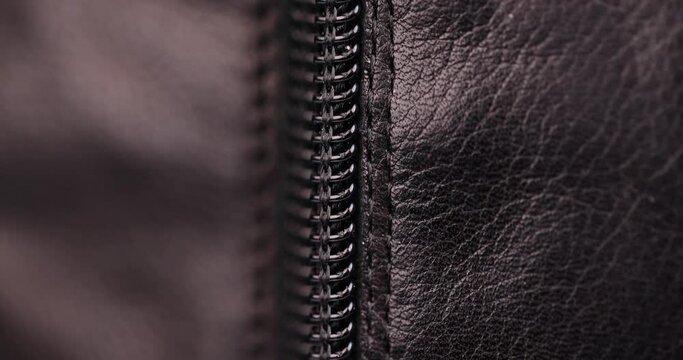 parts and details of clothing made of black leather, close-up of black leather with zipper