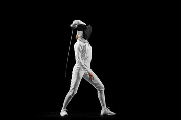Fencer's flawless attack, precision evident in her form against black studio background,...