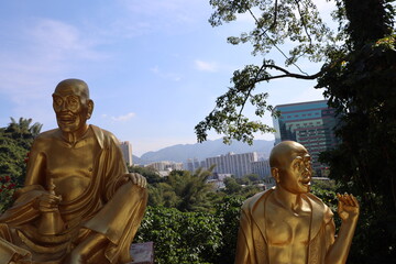 Golden buddha statue with Hong Kong skyline