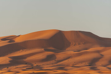 minimalist look of big sand dunes in the desert morocco with orange color view 