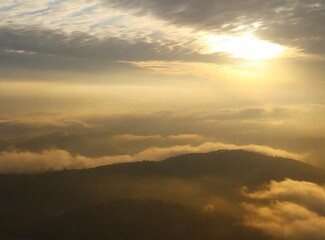 Obraz premium Flying through the clouds over the mountains
