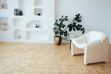 Modern interior with white walls and light parquet. Designer table consists of a glass top