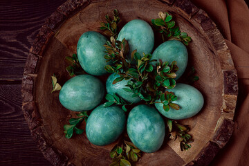 easter eggs, green, marble , boxwood, in a wooden plate, top view, homemade, no people,