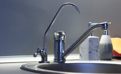 A close up of a modern filtered water tap, highlighting its sleek design. The filtered water tap...