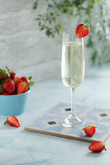 A glass of champagne with strawberries in summer style	