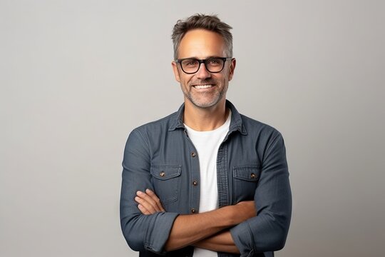 Handsome middle-aged man in eyeglasses smiling at camera.