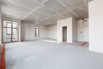 Fototapeta premium interior of the apartment without decoration in gray colors. rough finish