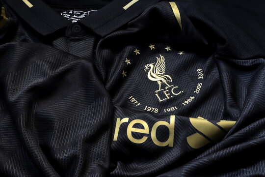 nice black soccer jersey or sports t shirt of Liverpool football club team in English premier league with club logo , Standard Charter logo and stars show that 6 times champion on table after wearing