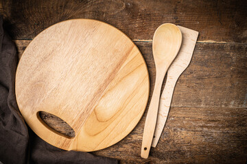 Old wooden kitchen utensils or cooking tools and bowls on wooden background, top view, flat lay. Kitchenware collection with copy space. Cooking background.